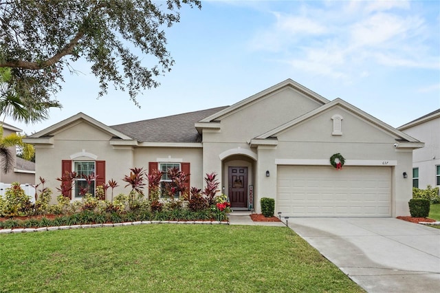 ranch-style house featuring a front yard and a garage