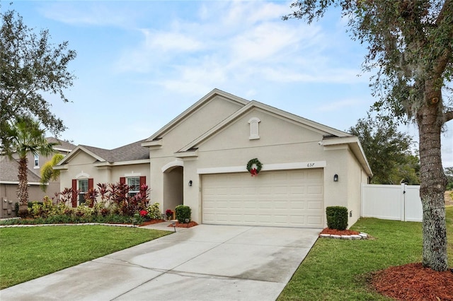 ranch-style home with a front yard and a garage