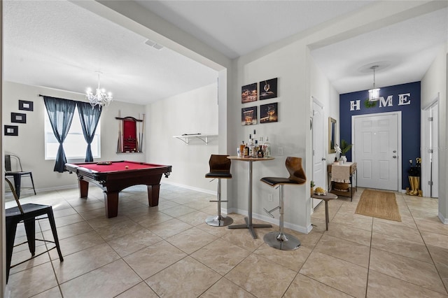 playroom with bar, light tile patterned floors, pool table, and an inviting chandelier