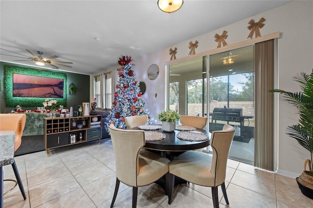 dining space with ceiling fan and light tile patterned floors