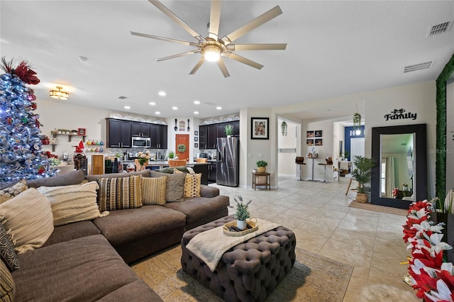 living room featuring ceiling fan and light tile patterned flooring