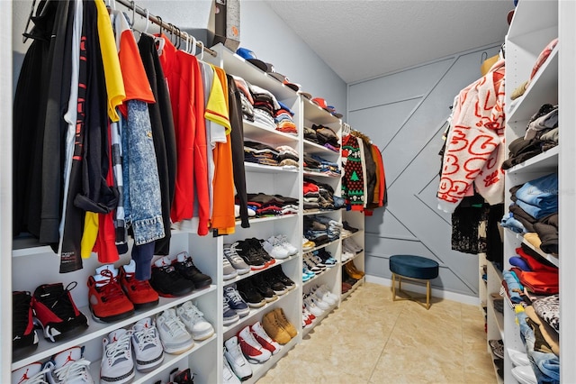 walk in closet with light tile patterned flooring