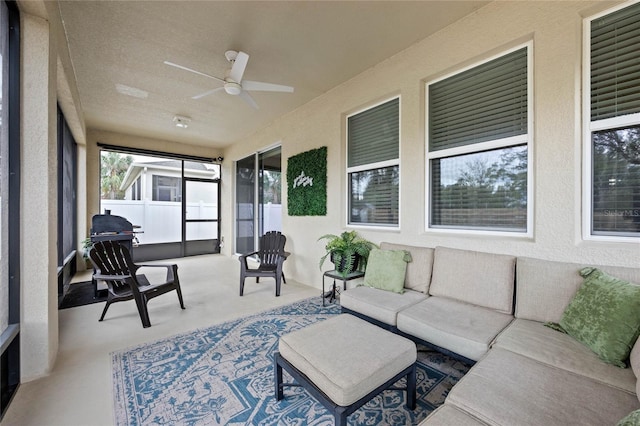 sunroom / solarium featuring ceiling fan