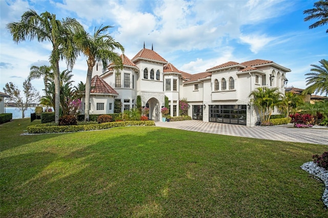 back of house featuring a garage and a yard