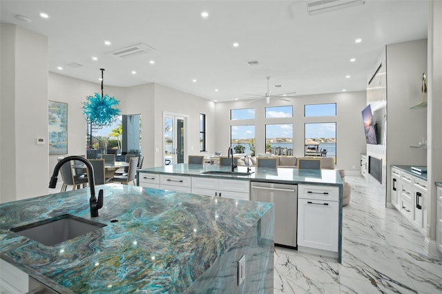 kitchen featuring a large island, sink, white cabinets, and dishwasher