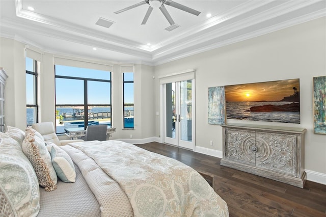 bedroom with ornamental molding, dark hardwood / wood-style floors, access to exterior, and a tray ceiling