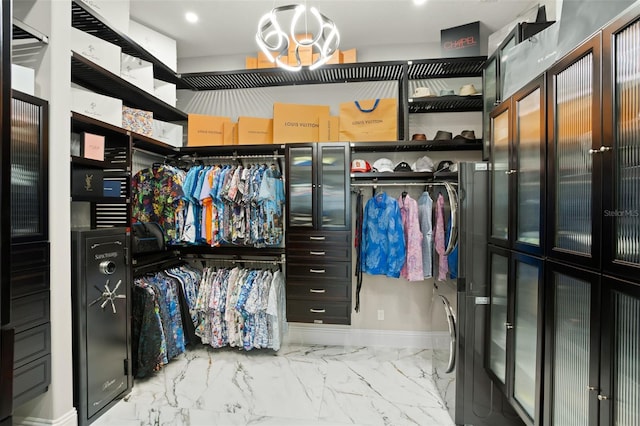 walk in closet featuring a notable chandelier