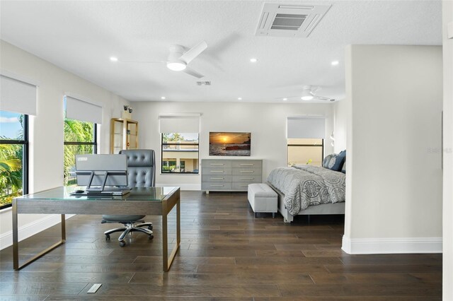 office featuring a textured ceiling, dark wood-type flooring, and ceiling fan