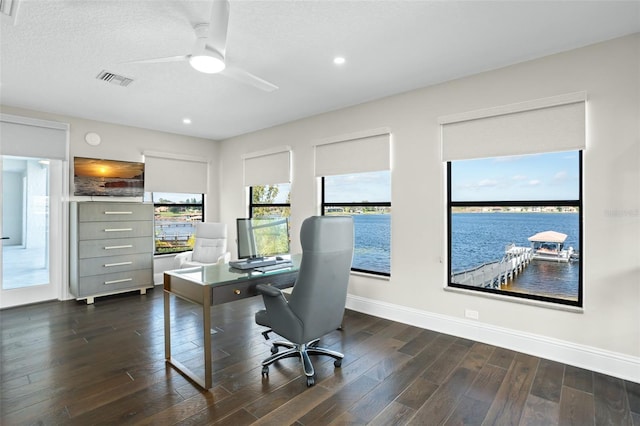 office space featuring a textured ceiling, dark wood-type flooring, and ceiling fan