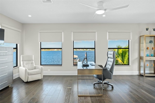 office area with ceiling fan, dark hardwood / wood-style floors, and a textured ceiling