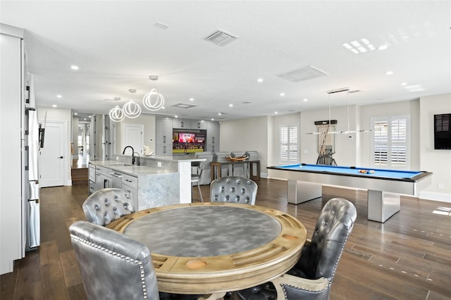 dining room with billiards, dark hardwood / wood-style floors, sink, and a textured ceiling