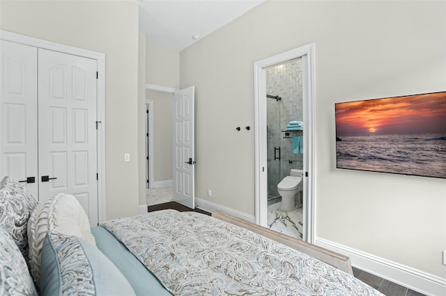 bedroom featuring ensuite bath, wood-type flooring, and a closet