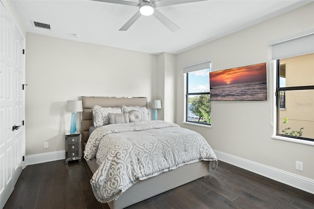 bedroom with dark hardwood / wood-style floors and ceiling fan