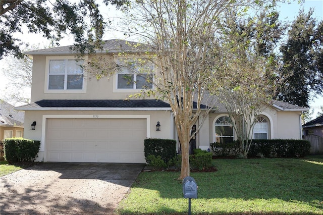 view of front of home featuring a front yard and a garage