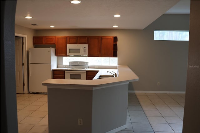 kitchen featuring kitchen peninsula, sink, light tile patterned floors, and white appliances