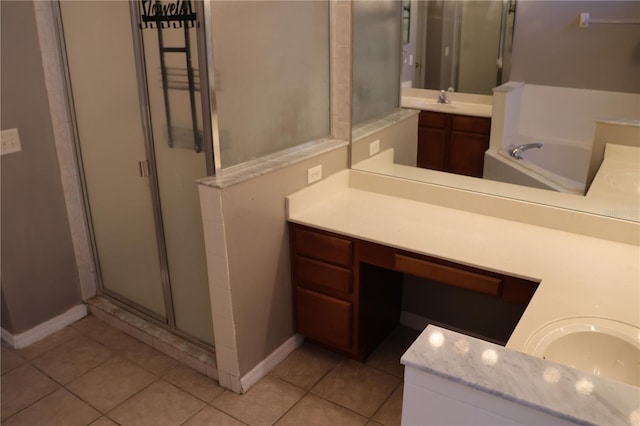 bathroom featuring plus walk in shower, vanity, and tile patterned flooring