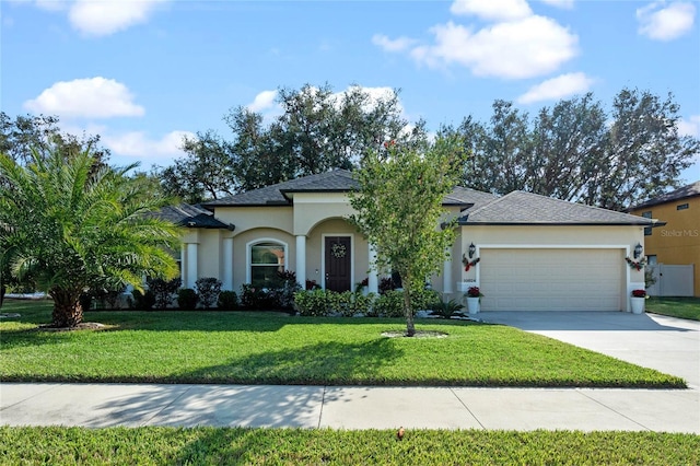 view of front facade with a front yard and a garage