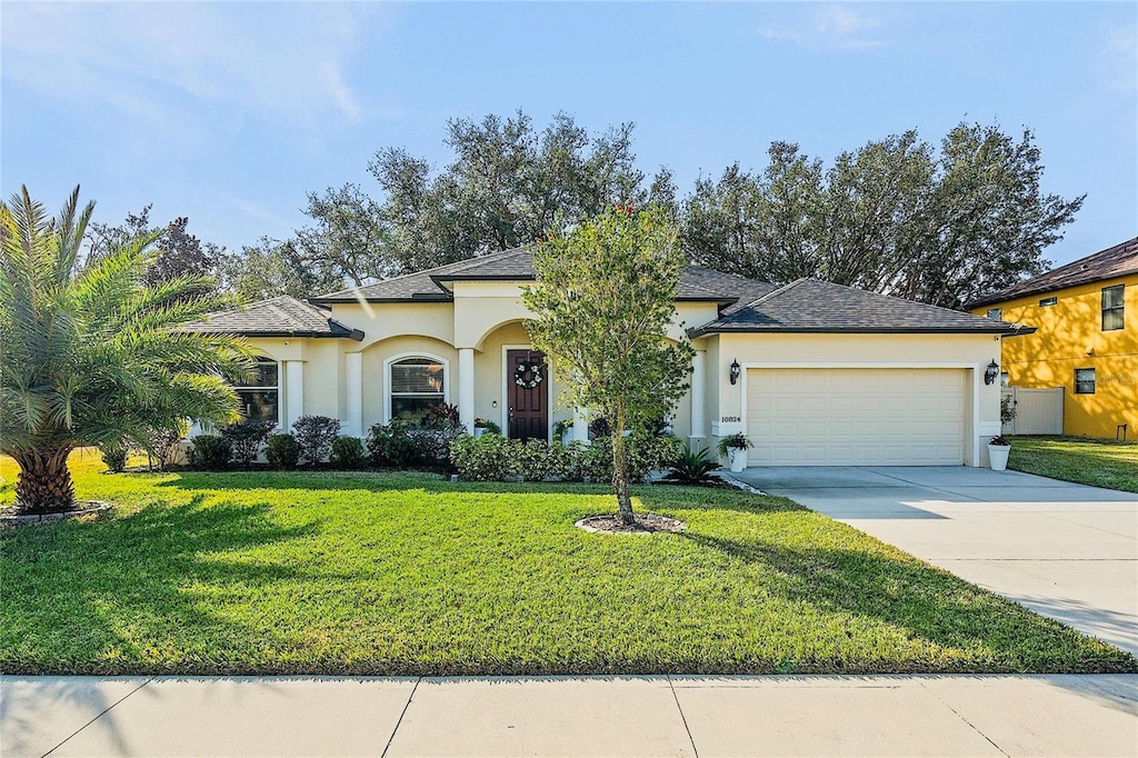 view of front of house with a garage and a front yard