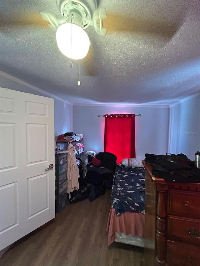 bedroom featuring wood-type flooring and a textured ceiling