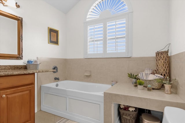 bathroom featuring a washtub, vanity, and tile patterned floors