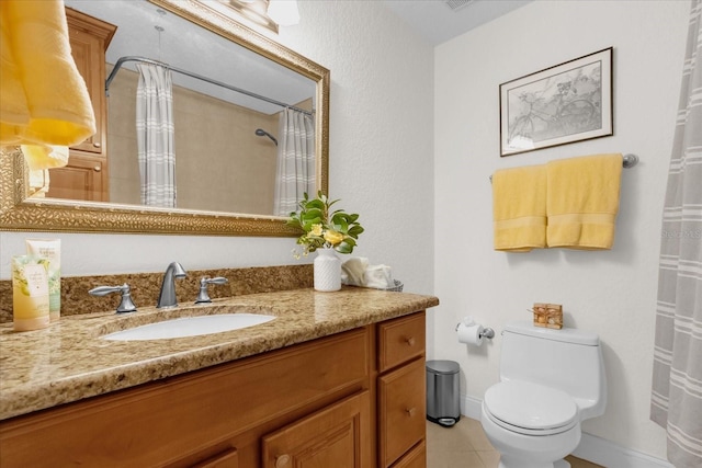 bathroom with tile patterned flooring, vanity, toilet, and walk in shower