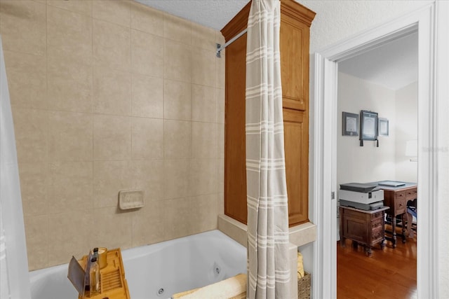 bathroom featuring wood-type flooring and shower / bath combo