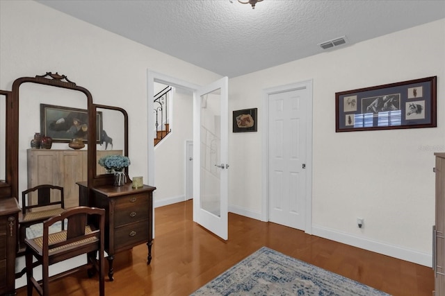 sitting room featuring hardwood / wood-style floors and a textured ceiling