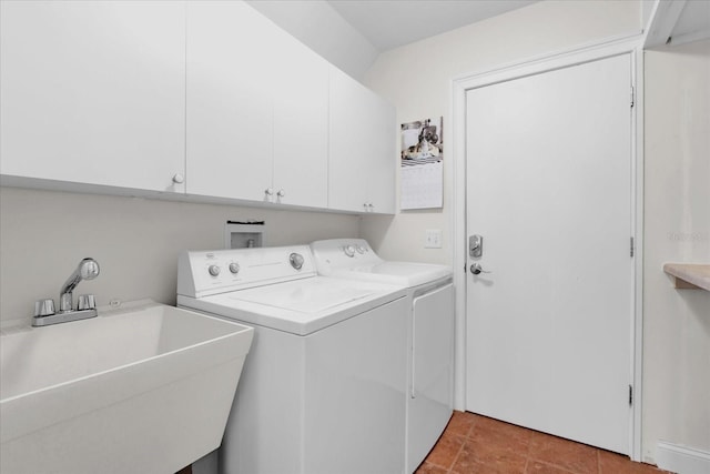 laundry room with washing machine and clothes dryer, cabinets, and sink