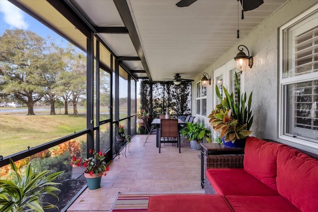 sunroom / solarium featuring ceiling fan