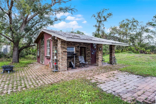 view of outbuilding with a lawn