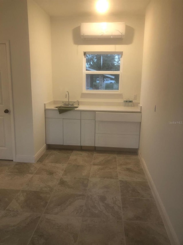 bathroom featuring a wall mounted air conditioner and vanity