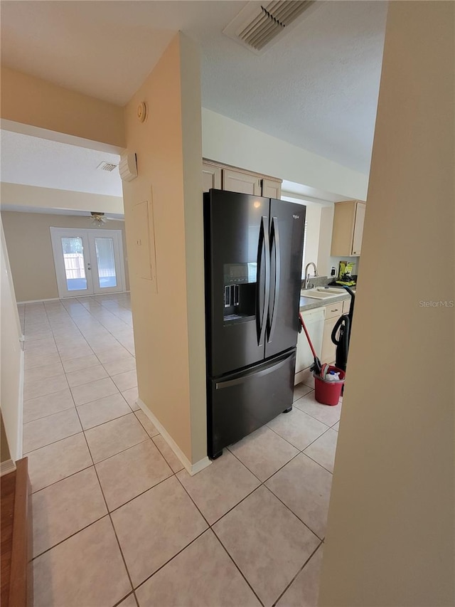 kitchen featuring black fridge, french doors, light tile patterned floors, and ceiling fan