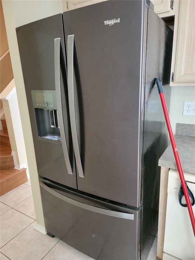 details featuring stainless steel fridge with ice dispenser and white cabinetry