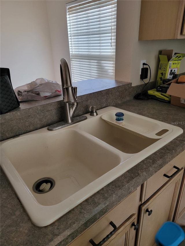 room details featuring sink and light brown cabinetry