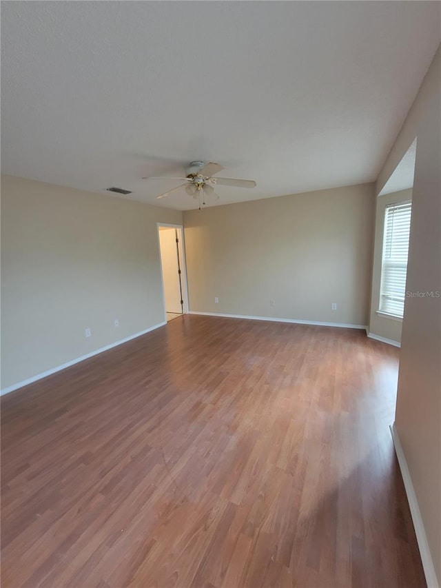 empty room featuring ceiling fan and wood-type flooring