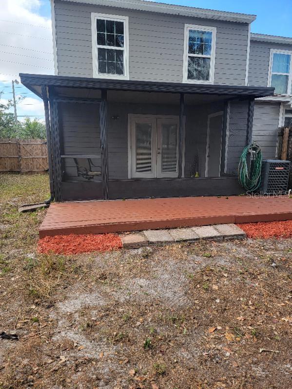 exterior space with french doors and cooling unit