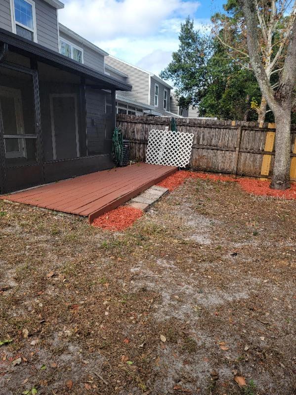 view of yard with a wooden deck and a sunroom