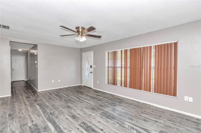 spare room featuring wood-type flooring and ceiling fan