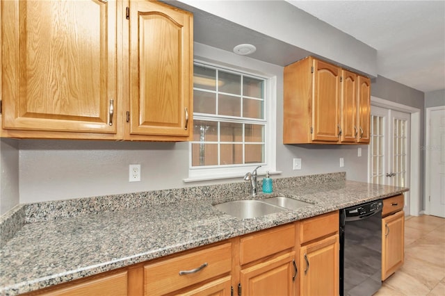 kitchen featuring dishwasher, light tile patterned flooring, light stone counters, and sink