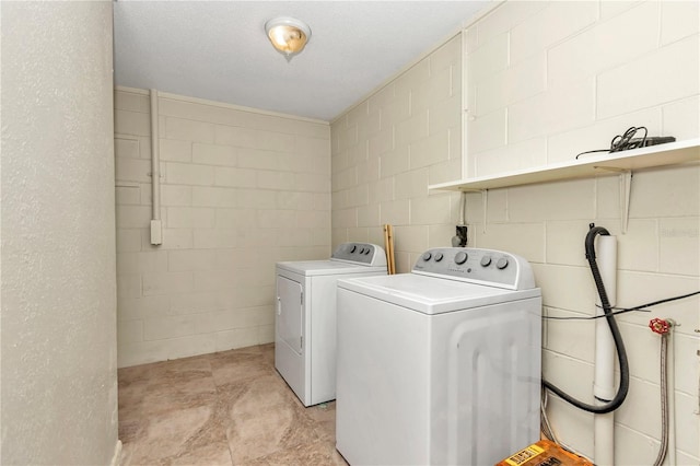 clothes washing area featuring washer and dryer