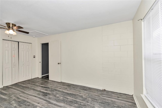 unfurnished bedroom with a closet, ceiling fan, and dark hardwood / wood-style flooring