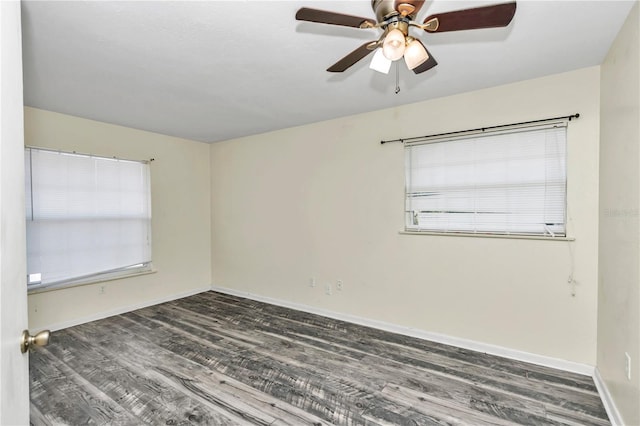 spare room with dark hardwood / wood-style floors and ceiling fan