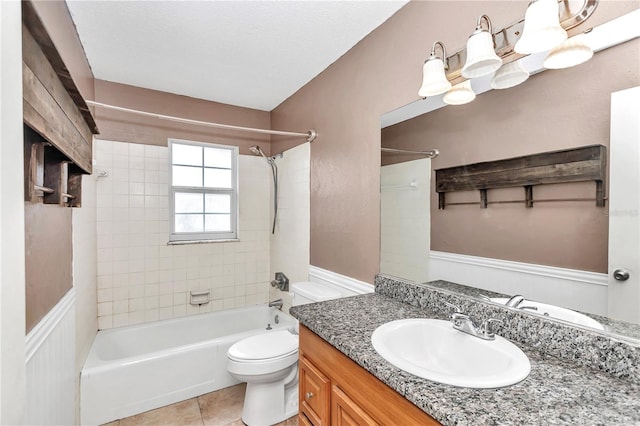 full bathroom featuring tile patterned floors, vanity, toilet, and tiled shower / bath