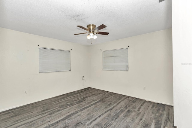 empty room with ceiling fan, dark hardwood / wood-style flooring, and a textured ceiling