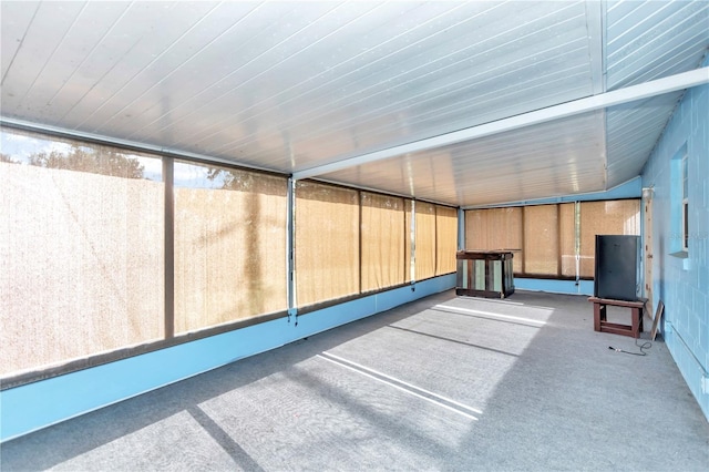 unfurnished sunroom featuring lofted ceiling