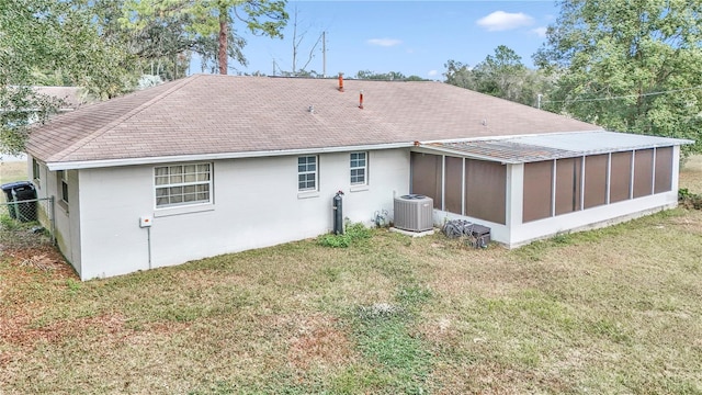 back of property featuring a sunroom, cooling unit, and a yard