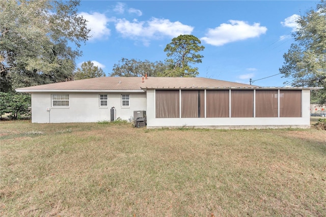 back of house featuring a sunroom and a yard