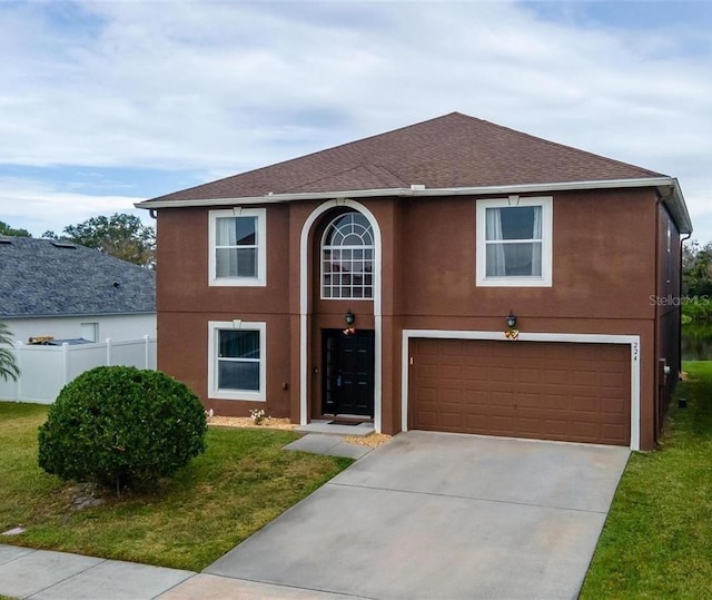 view of front facade with a garage and a front yard