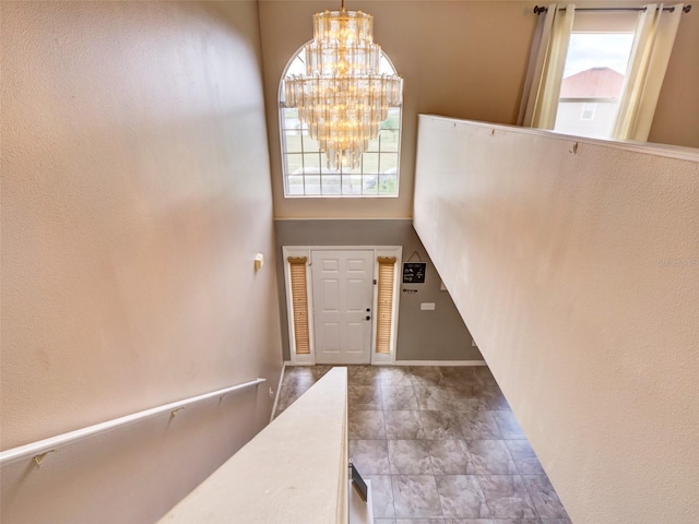 entryway featuring a chandelier and a towering ceiling