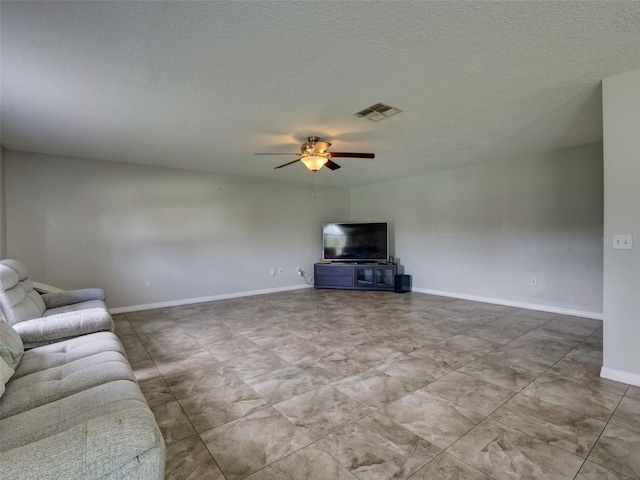 unfurnished living room featuring ceiling fan and a textured ceiling